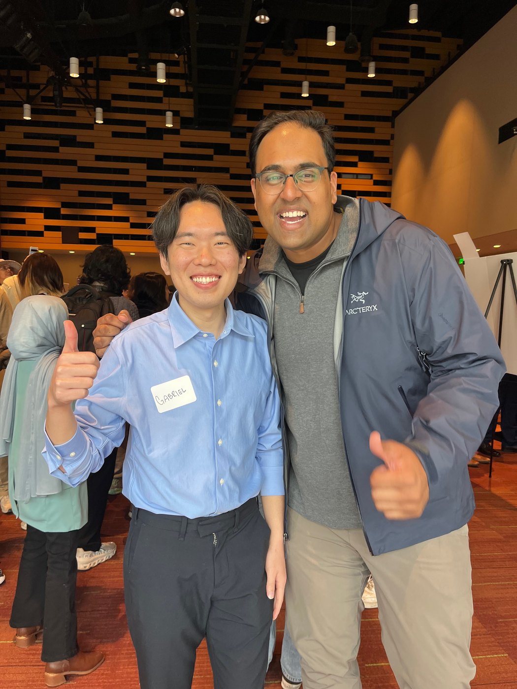 me with a friend at an event, thumbs up